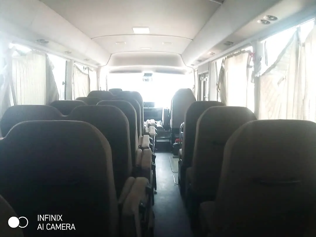 View down the centre aisle of the Coaster bus toward the rear seats