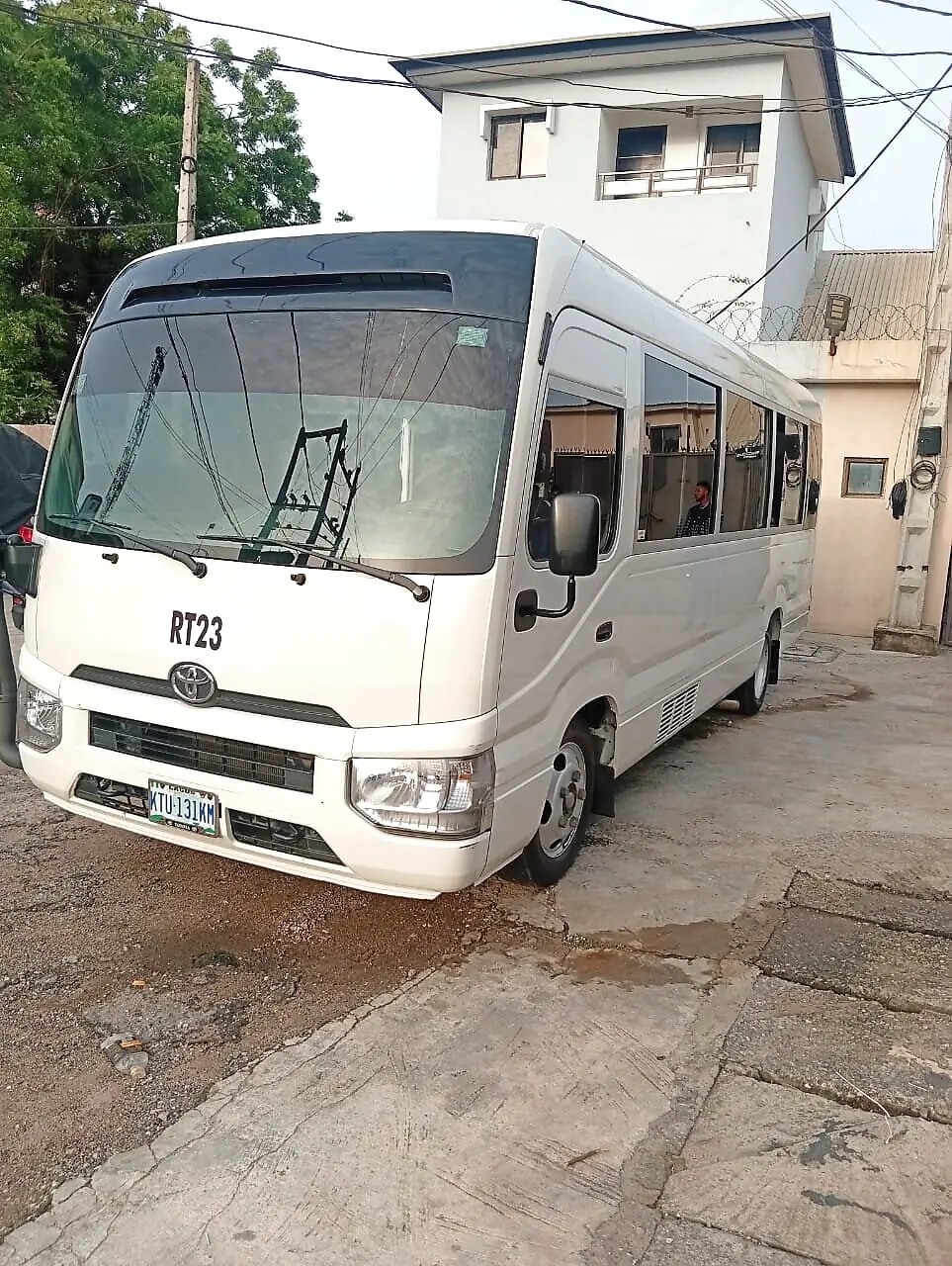 Side-front view of the Toyota Coaster platform used for Totrip's armoured Coaster rental in Lagos