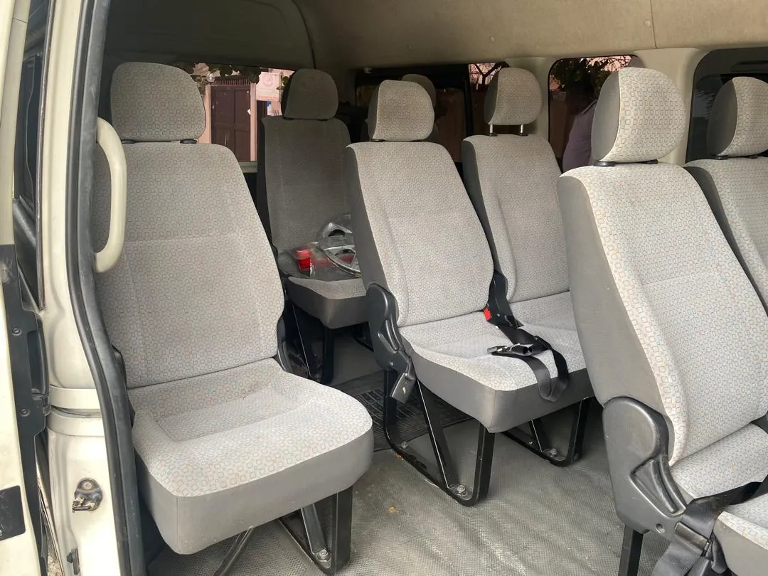 Toyota Hiace passenger seat rows seen through the open side door