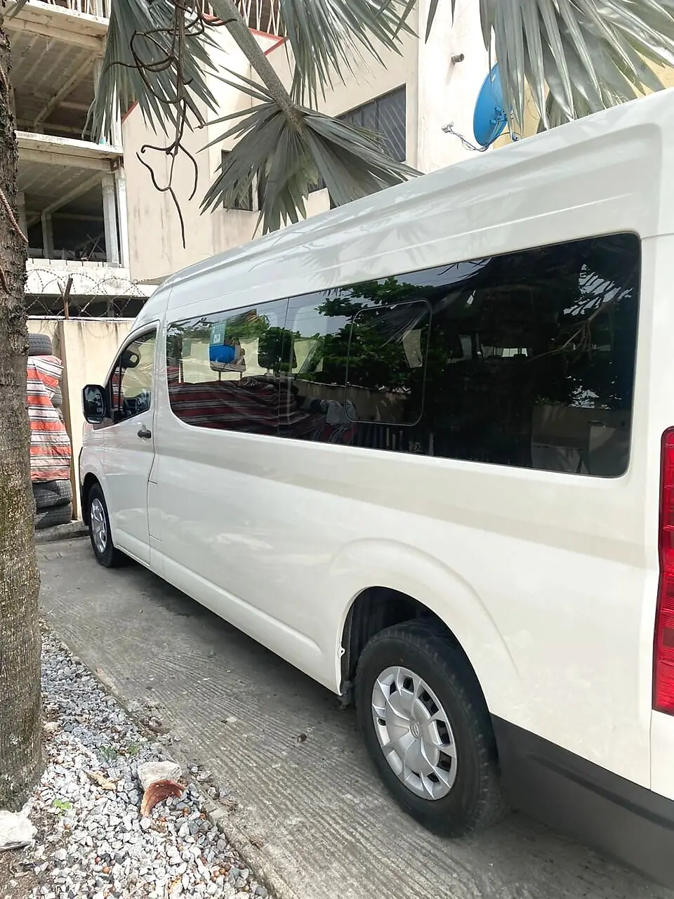 Side view of the Hiace bus showing tinted passenger windows