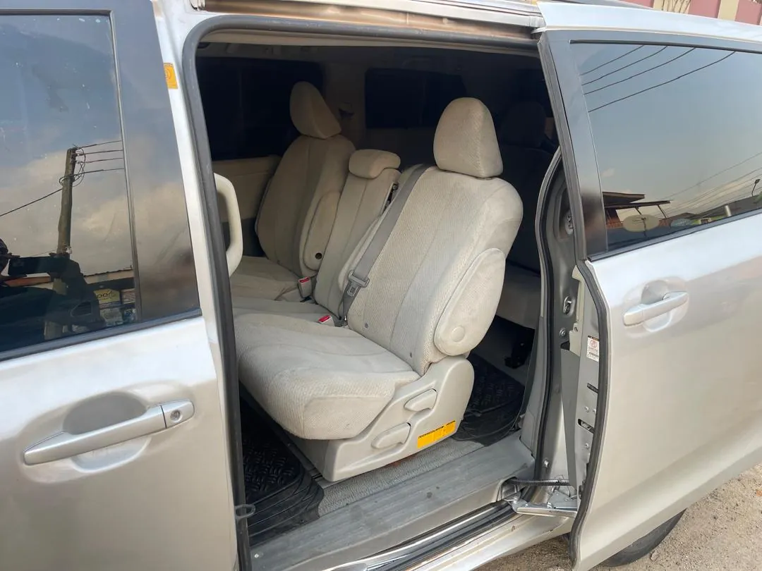 Toyota Sienna sliding side door open showing beige second-row seats